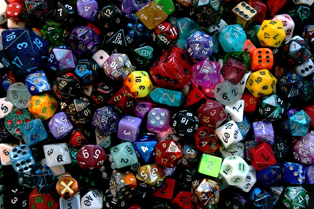 collection of various gaming dice, ranging froim d4 to d20, different sizes and colouras, occasional odd symbol every now and then